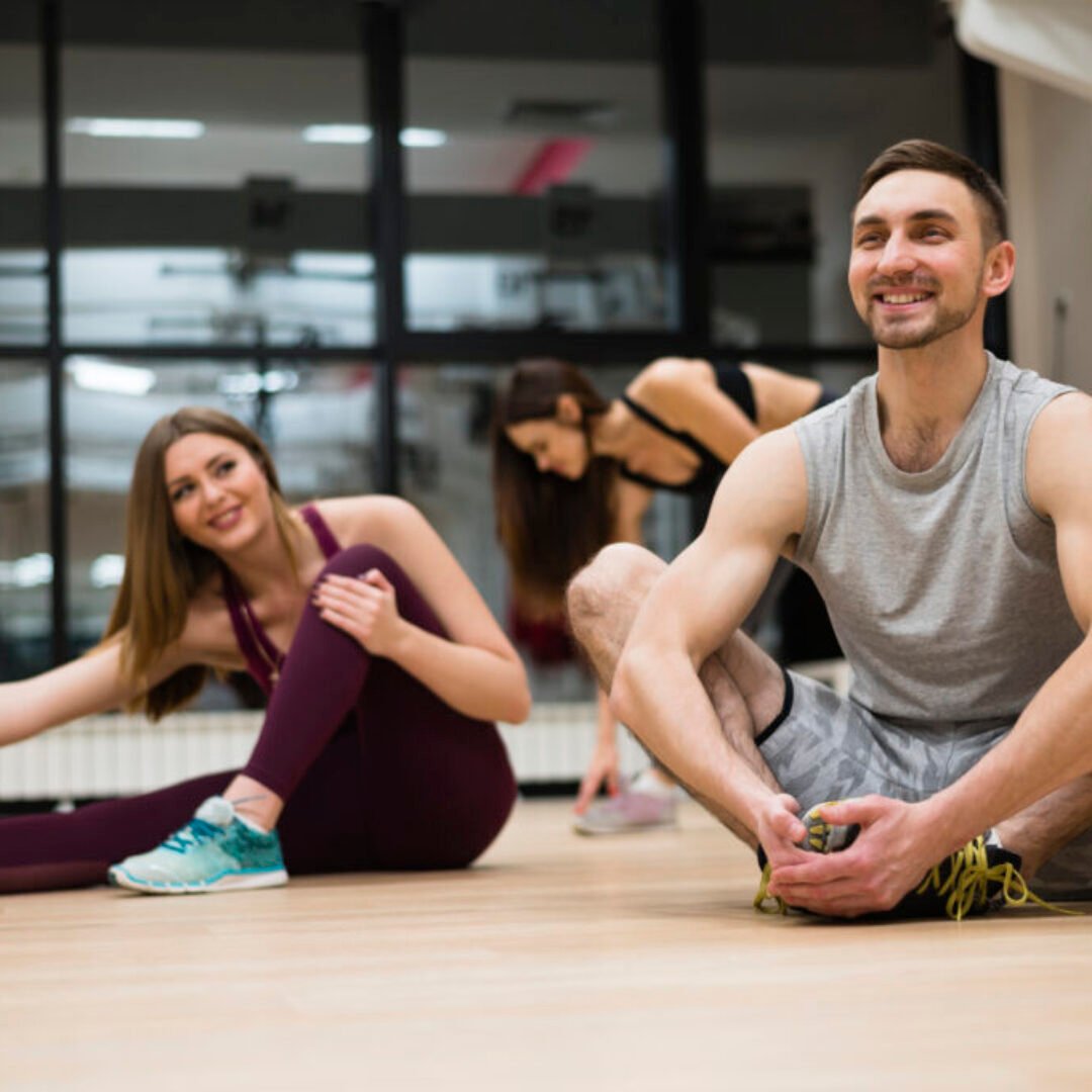 women-stretching-together-with-trainer